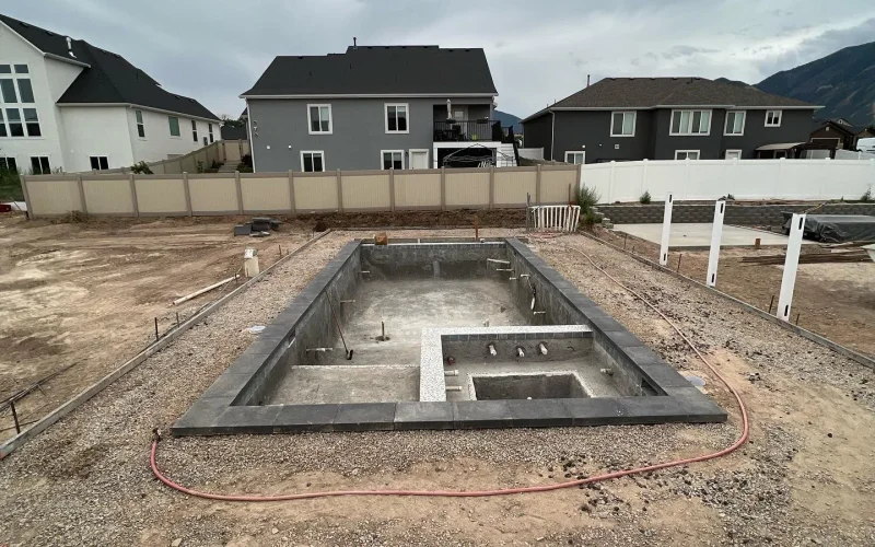 Gunite pool mid-construction showing rebar and fresh shotcrete work